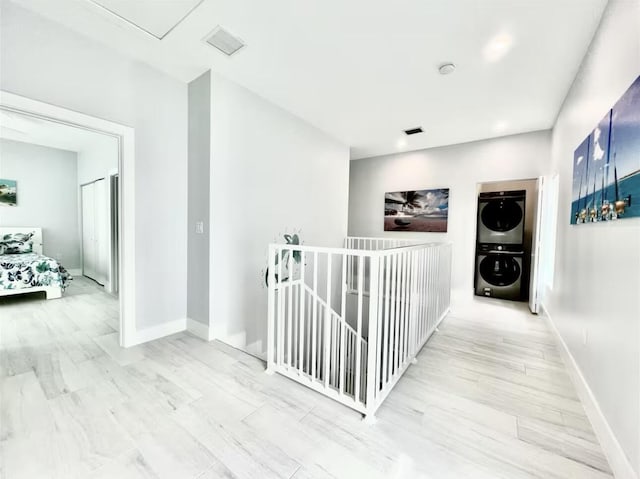 1021 82nd St, Marathon, FL 33050 - corridor featuring stacked washer / drying machine, baseboards, visible vents, and wood finished floors