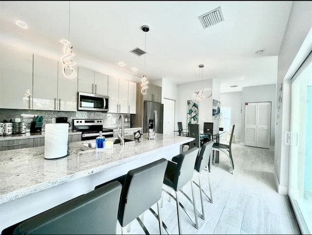 1021 82nd St, Marathon, FL 33050 - kitchen with a sink, stainless steel appliances, backsplash, and visible vents