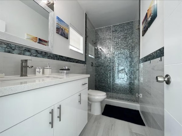 1021 82nd St, Marathon, FL 33050 - bathroom with vanity, a shower stall, toilet, and tile walls