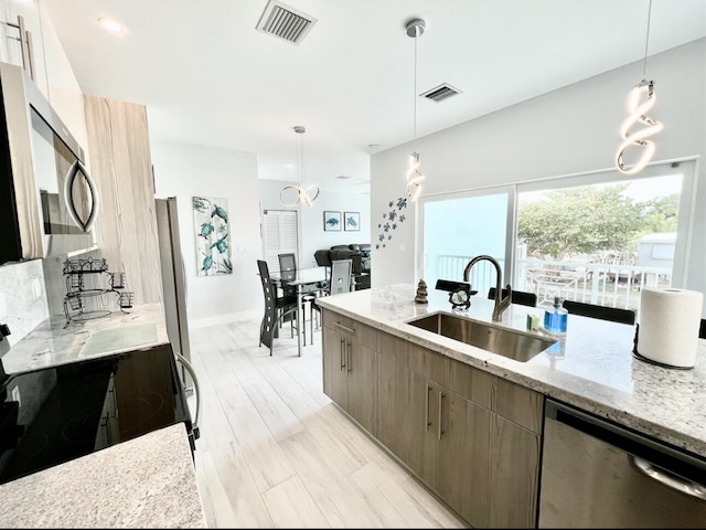 1021 82nd St, Marathon, FL 33050 - kitchen featuring a sink, stainless steel appliances, light stone counters, and visible vents