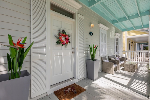 view of exterior entry with covered porch