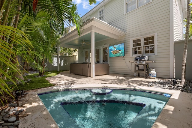 exterior space with a patio area, ceiling fan, and an in ground hot tub