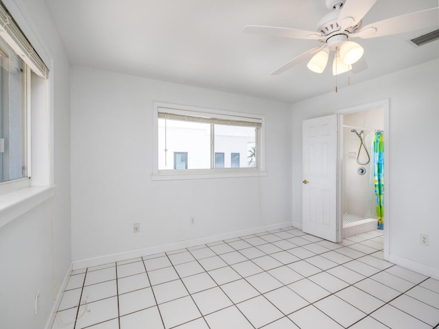 tiled spare room with ceiling fan