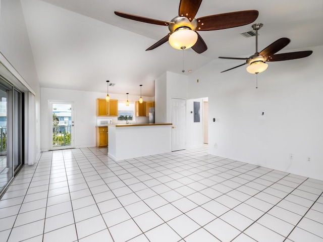 unfurnished living room featuring light tile patterned floors, electric panel, and high vaulted ceiling