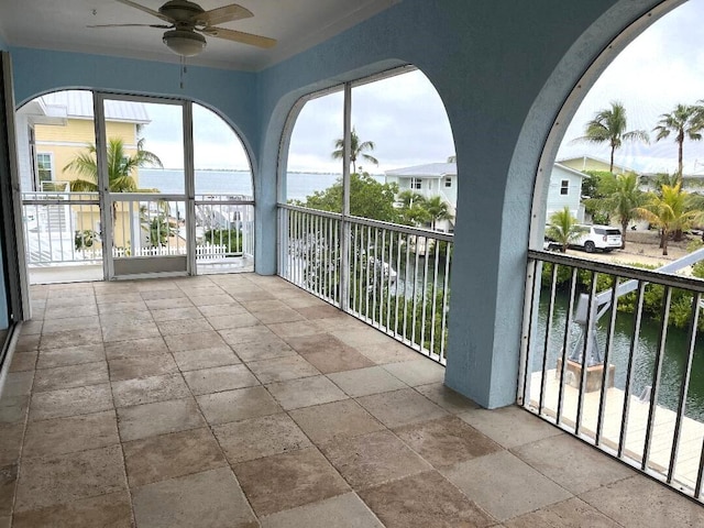 exterior space with a water view and ceiling fan