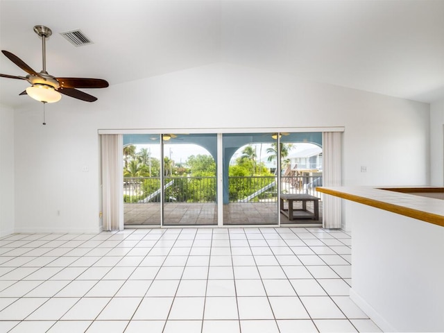 tiled empty room featuring vaulted ceiling and ceiling fan