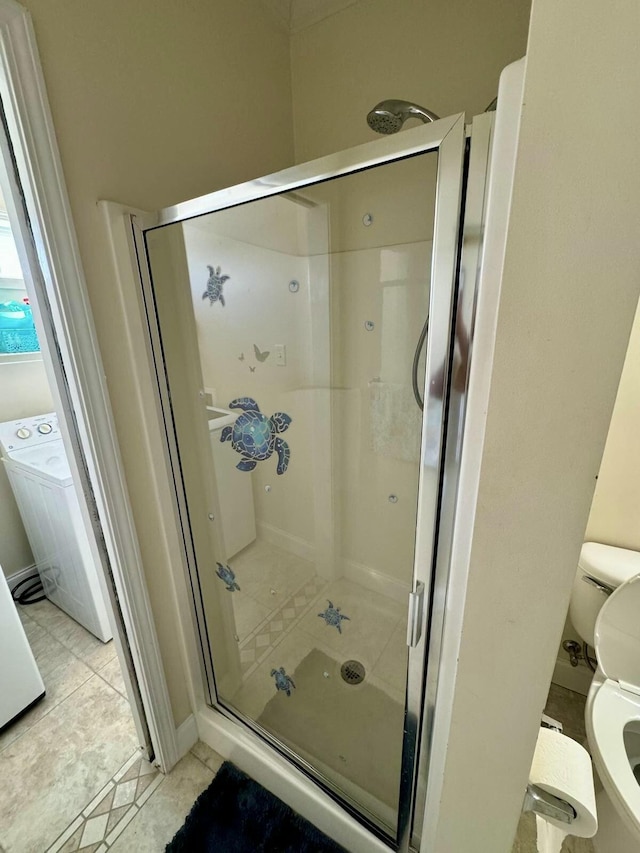 full bath with a shower stall, toilet, and tile patterned floors