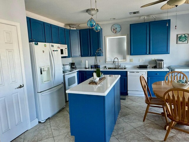 kitchen featuring white appliances, light countertops, crown molding, blue cabinetry, and a sink