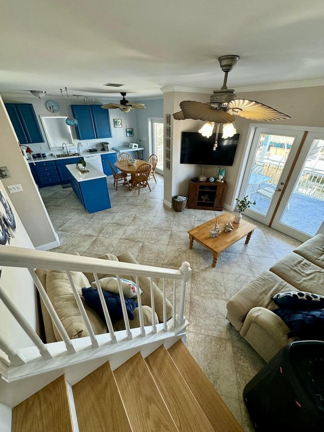 living room featuring ornamental molding and a ceiling fan
