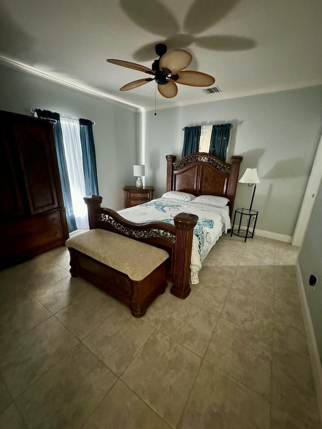 bedroom with light tile patterned flooring, a ceiling fan, and baseboards