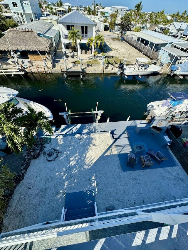 view of dock featuring a water view and a residential view