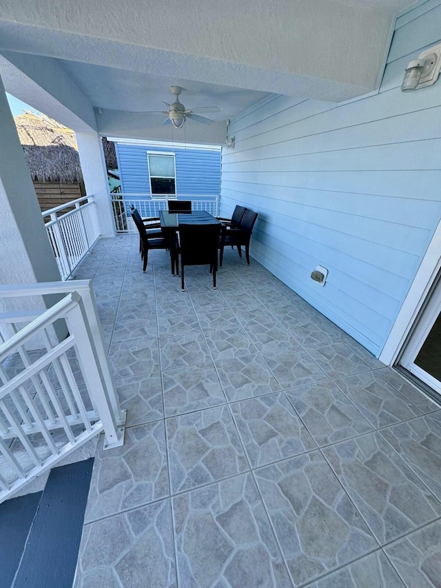 view of patio featuring outdoor dining area and a ceiling fan
