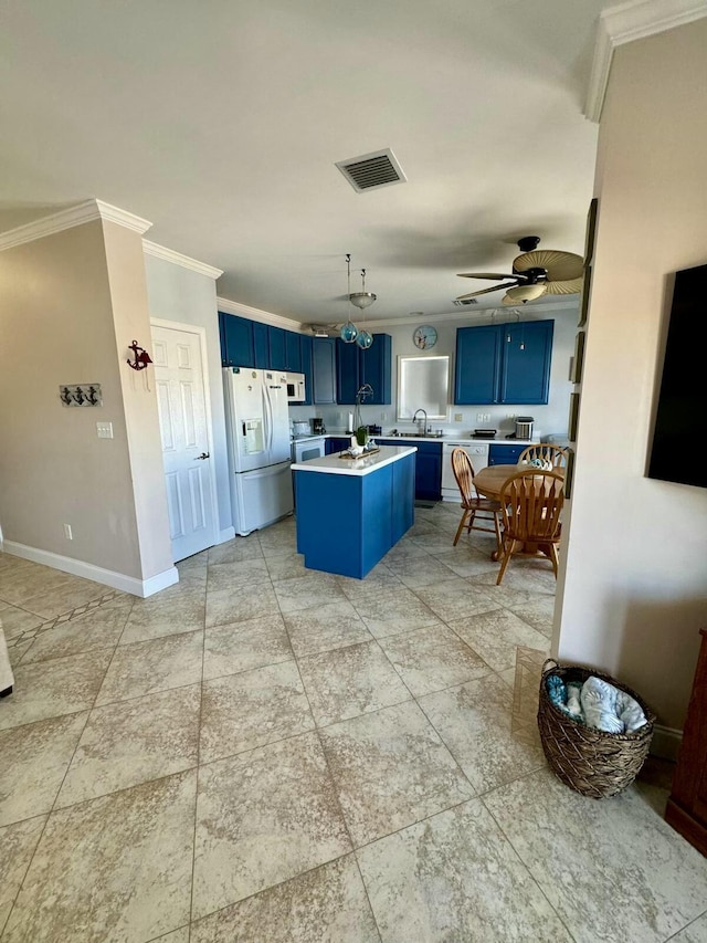 kitchen with white refrigerator with ice dispenser, visible vents, light countertops, ornamental molding, and blue cabinetry