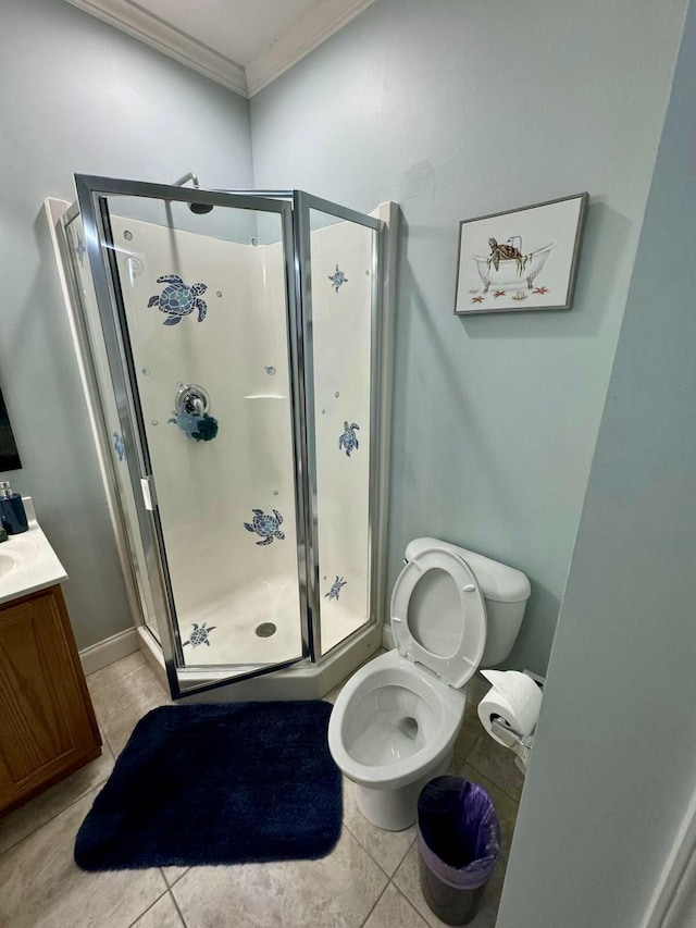 bathroom featuring ornamental molding, tile patterned flooring, a stall shower, and vanity