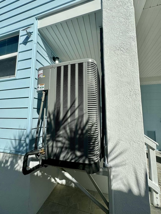 details with central AC and stucco siding
