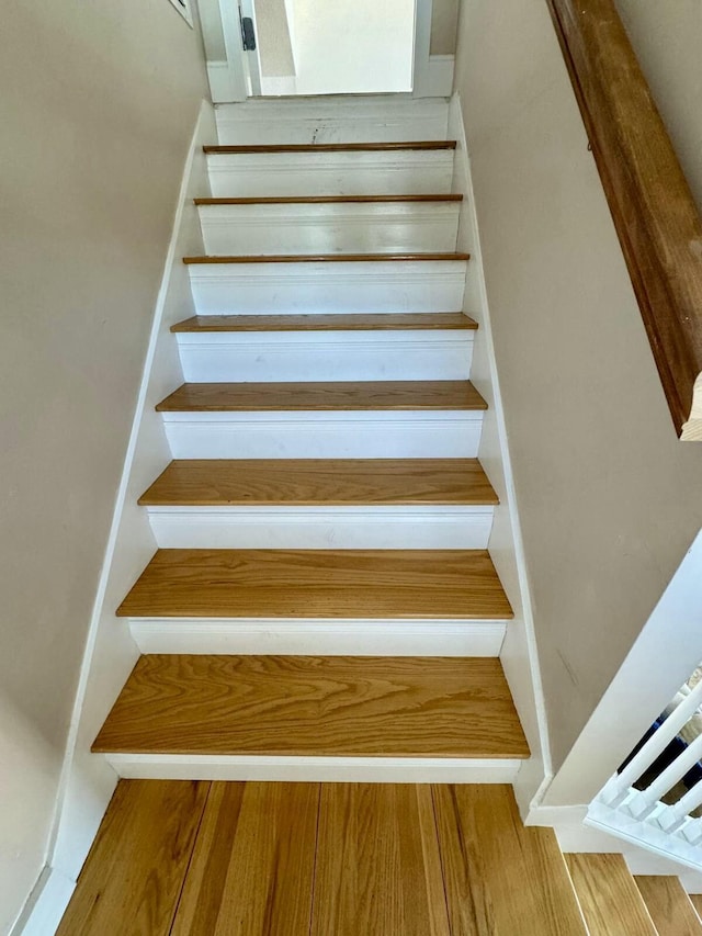stairs featuring wood finished floors