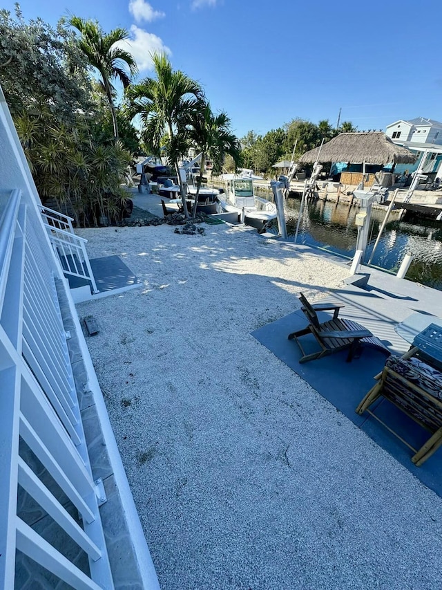 exterior space with a dock and a water view