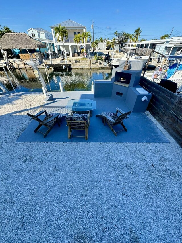 view of dock with a patio area and a water view