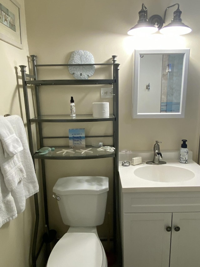 bathroom featuring vanity and toilet