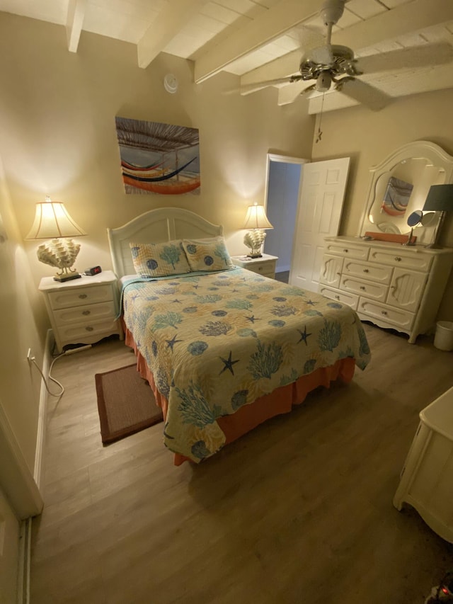 bedroom featuring beam ceiling, ceiling fan, and light wood-type flooring