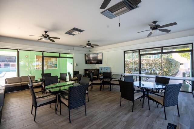 dining area with plenty of natural light and wood-type flooring