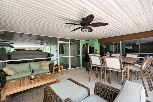 sunroom featuring ceiling fan