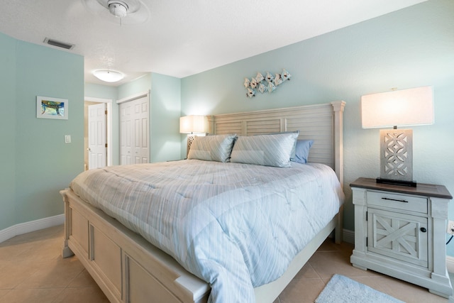 tiled bedroom with a closet