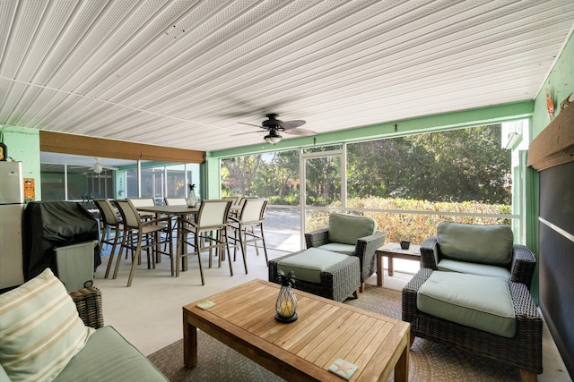 sunroom / solarium featuring ceiling fan