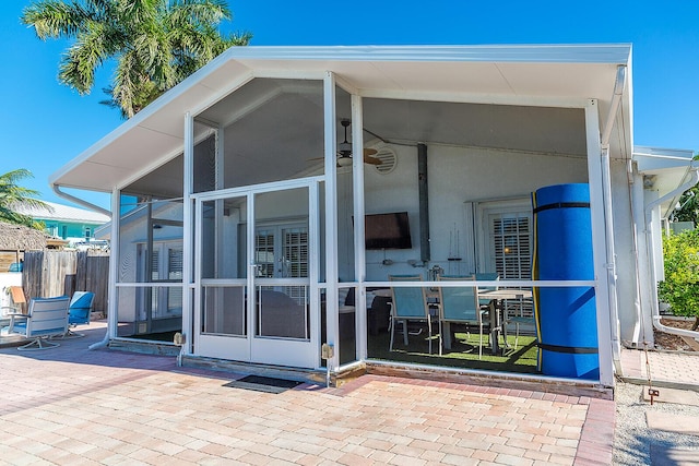 rear view of property featuring a sunroom