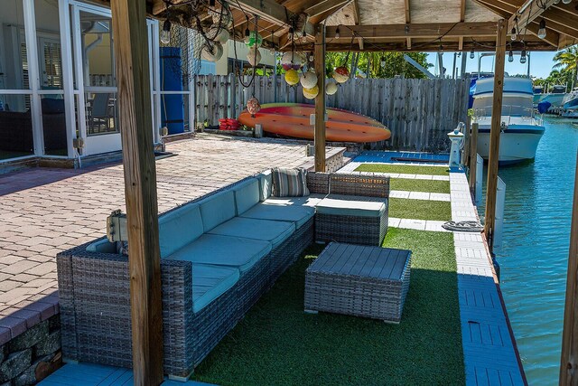 view of patio / terrace with a water view, an outdoor living space, and a gazebo