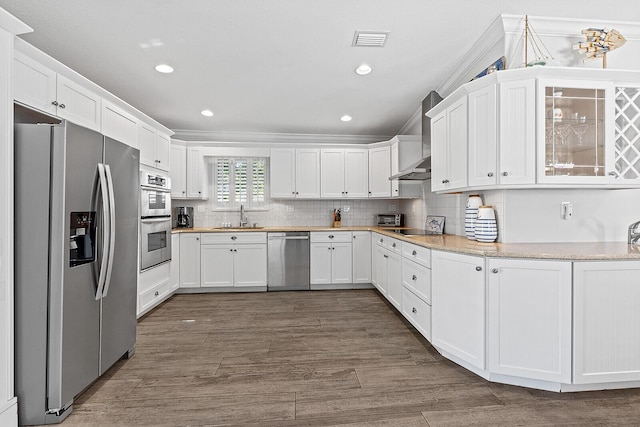 kitchen with sink, white cabinetry, tasteful backsplash, appliances with stainless steel finishes, and dark hardwood / wood-style flooring