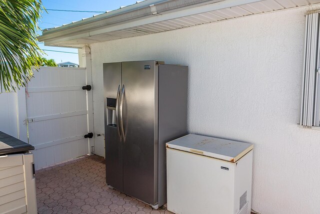 kitchen with fridge and stainless steel fridge with ice dispenser