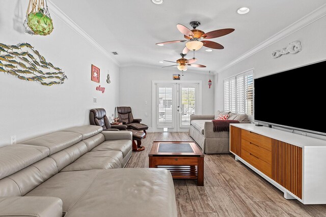 living room featuring crown molding, ceiling fan, and wood-type flooring