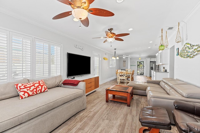 living room with ornamental molding, ceiling fan, and light wood-type flooring