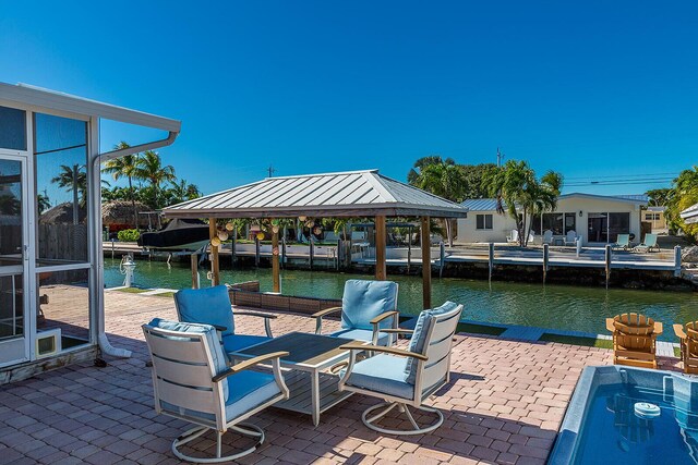 dock area with a gazebo and a water view