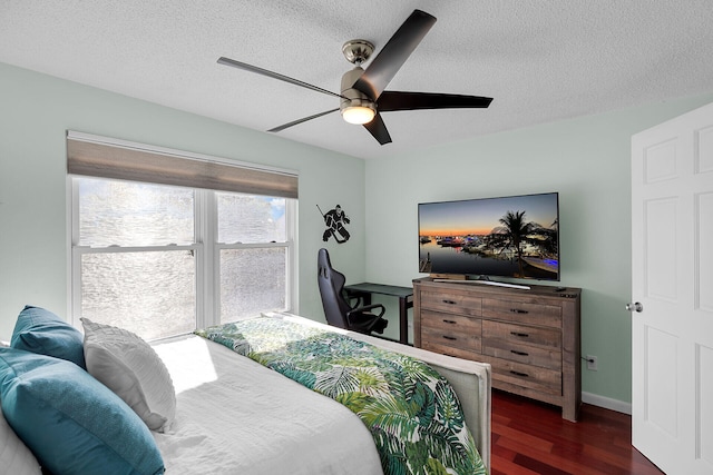 3314 Northside Dr Unit 86, Key West, FL 33040 - bedroom with dark wood-style floors, a textured ceiling, a ceiling fan, and baseboards