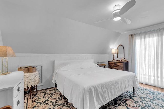 bedroom featuring lofted ceiling, light hardwood / wood-style flooring, and ceiling fan