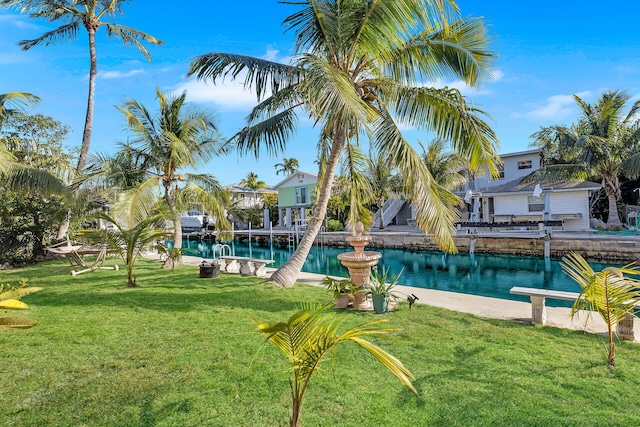 view of pool featuring a lawn and a water view