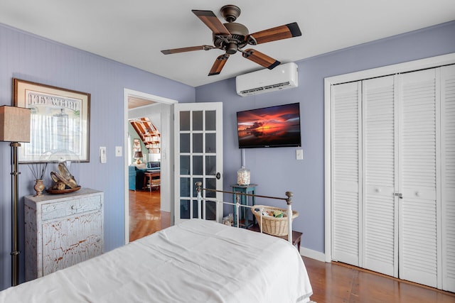 bedroom featuring a wall unit AC, a closet, and ceiling fan