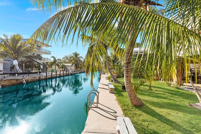 view of swimming pool with a lawn