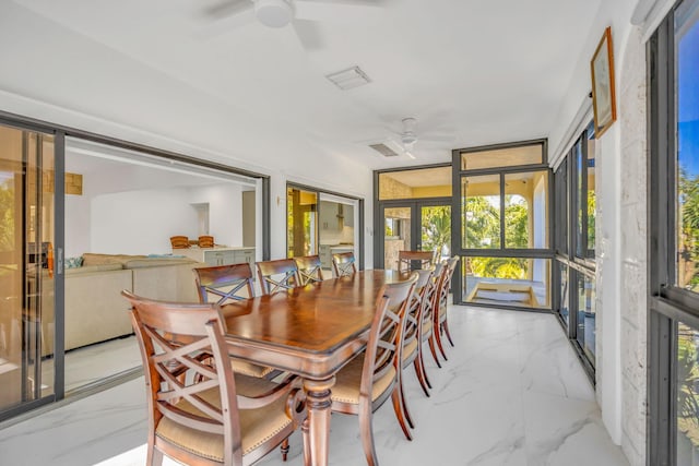 sunroom featuring ceiling fan