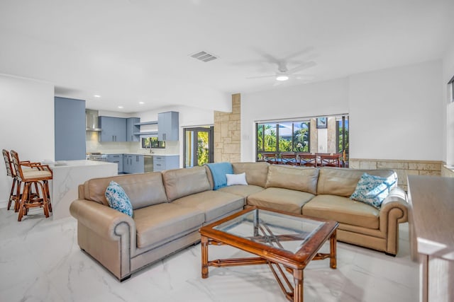 living room with ceiling fan and sink