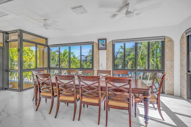 sunroom / solarium featuring plenty of natural light and ceiling fan