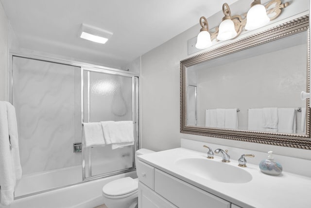 full bathroom with vanity, enclosed tub / shower combo, and toilet