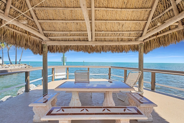 view of dock with a gazebo and a water view