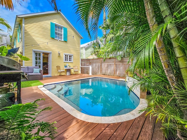 view of swimming pool with a deck