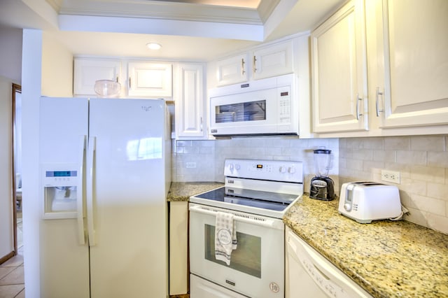 kitchen with tasteful backsplash, white appliances, white cabinetry, and light stone countertops