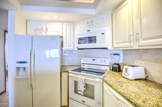 1133 W Ocean Dr Unit 2, Key Colony, FL 33051 - kitchen with white cabinets, white appliances, ornamental molding, tasteful backsplash, and light stone counters