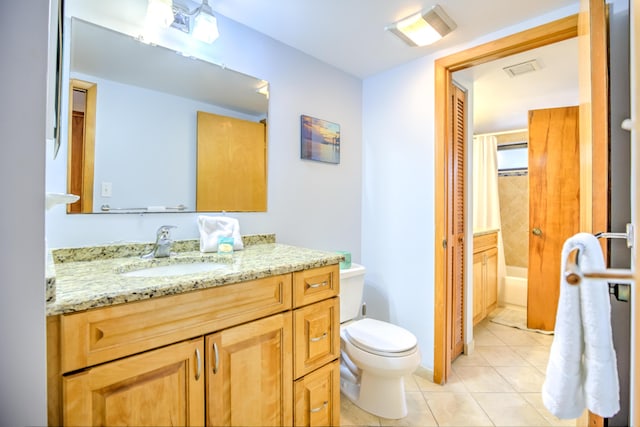 bathroom with vanity, toilet, and tile patterned floors