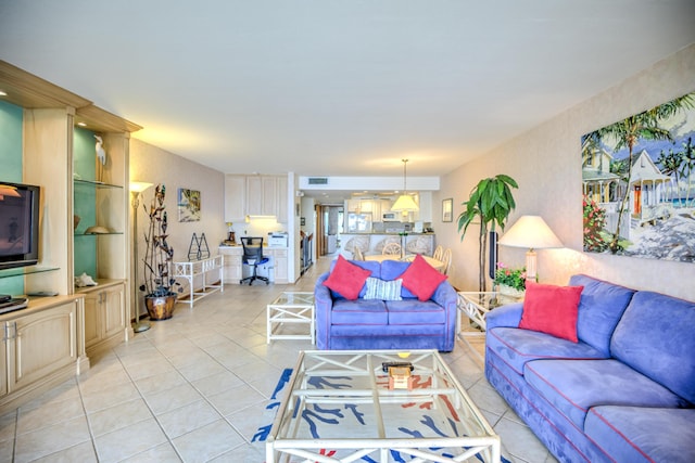 living room featuring light tile patterned floors and visible vents